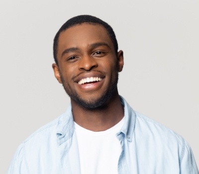 Smiling man in light blue collared shirt
