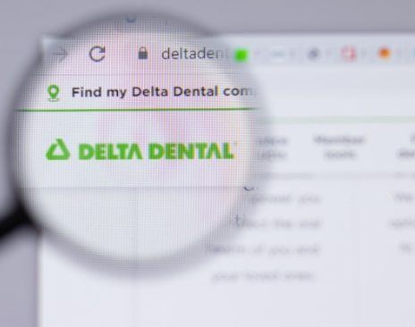 Magnifying glass showing computer screen on Delta Dental website