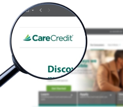 Magnifying glass showing Care Credit logo on their website