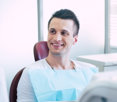 Man in dental chair listening to his dentist