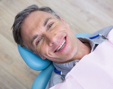 Smiling man leaning back in dental chair