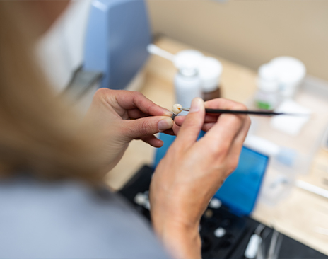 Ceramist designing a dental crown