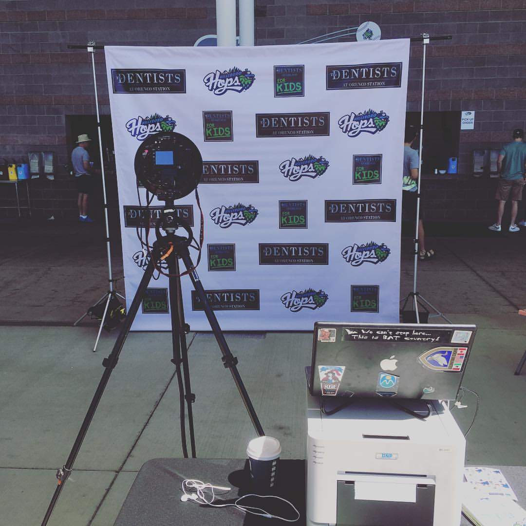 Camera pointing to background showing multiple logos for The Dentists at Orenco Station