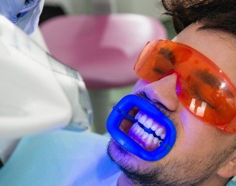 Man in dental chair getting professional teeth whitening