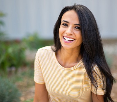 Woman with striped yellow shirt smiling