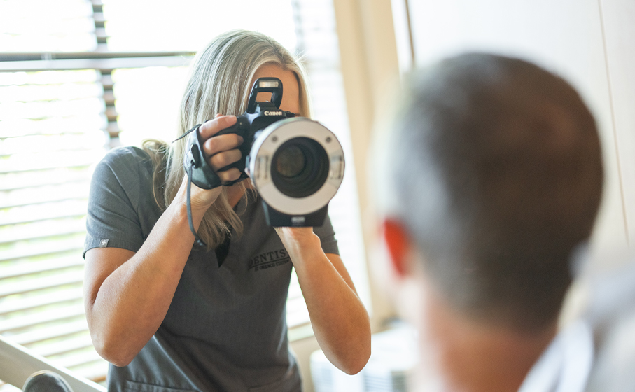 Hillsboro dentist using large camera to take photo of patient