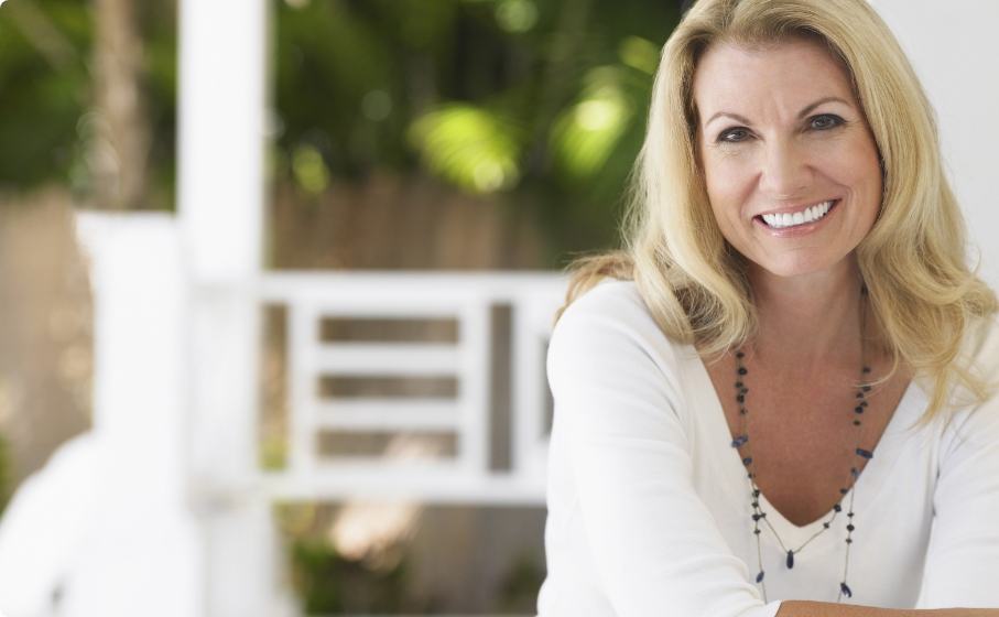 Smiling blonde woman in white blouse