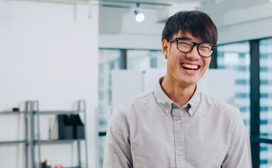 Man in office building smiling after preventive dentistry checkup in Hillsboro