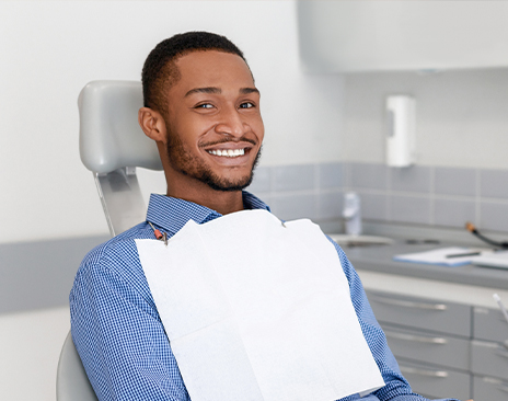Smiling man sitting in dental chair