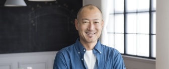 Smiling man in blue collared shirt