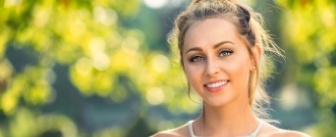 Blonde woman smiling outdoors