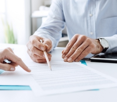 Two people looking at paperwork at desk