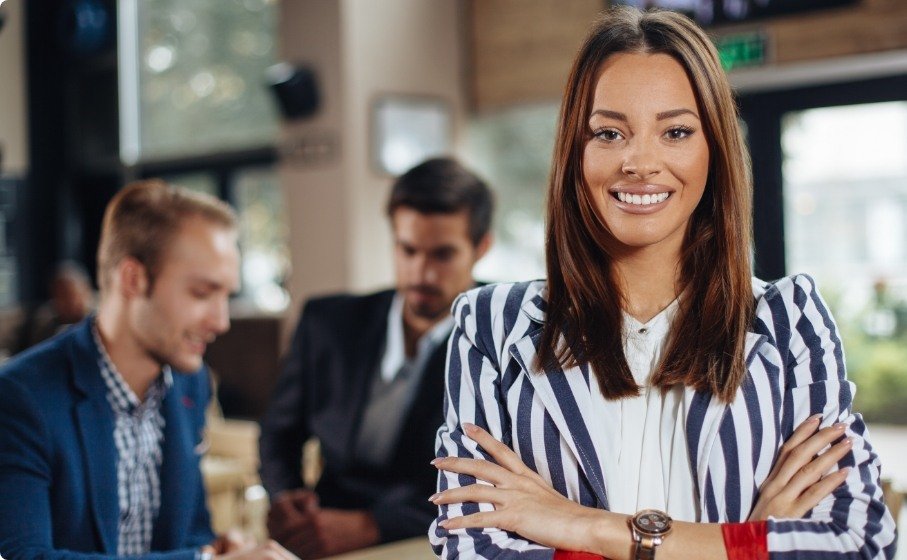 Woman in office building smiling with veneers in Hillsboro