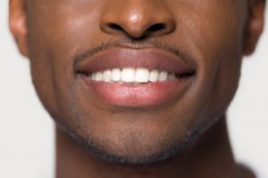 Man smiling with straight, white teeth