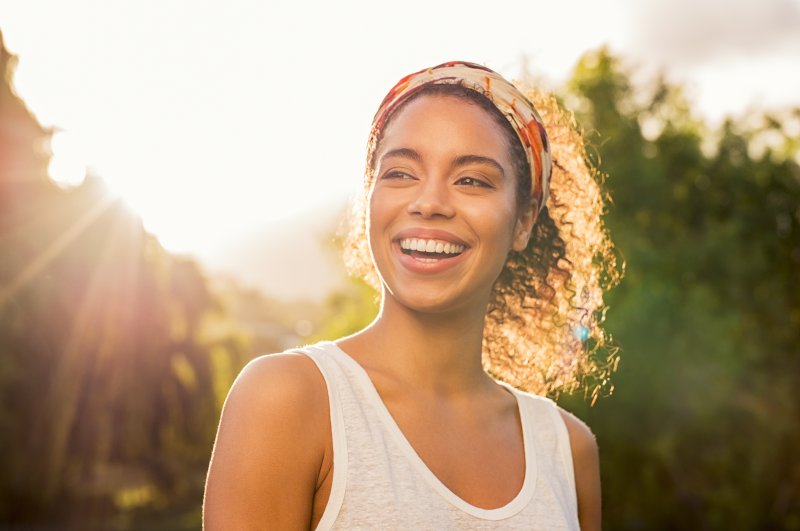 Woman smiling outdoors in the sun