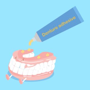 Illustration of denture cream being squeezed onto a happy set of dentures