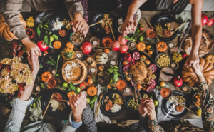 Family holding hands over Thanksgiving meal